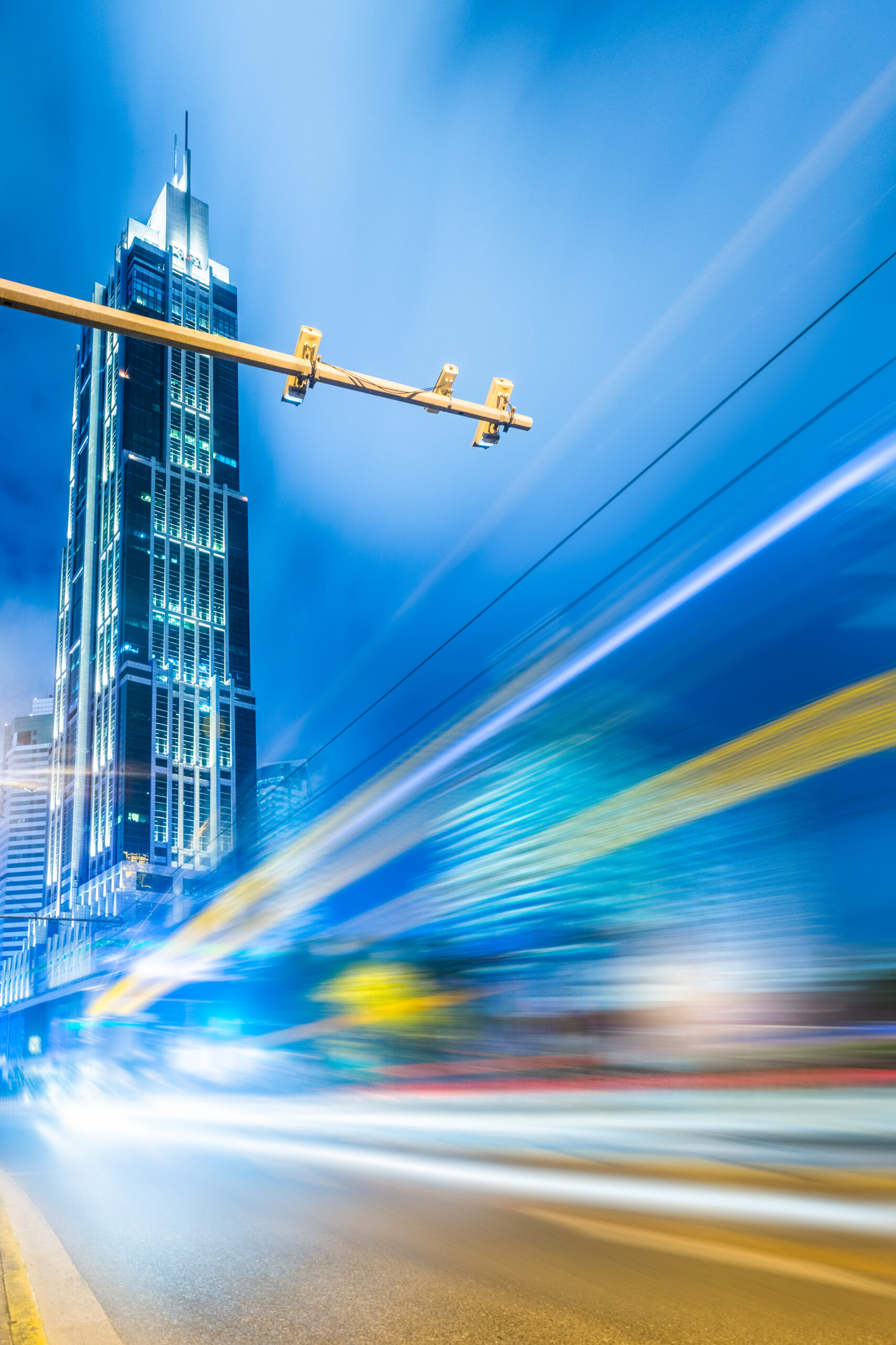 blurred traffic light trails on road at night in China.